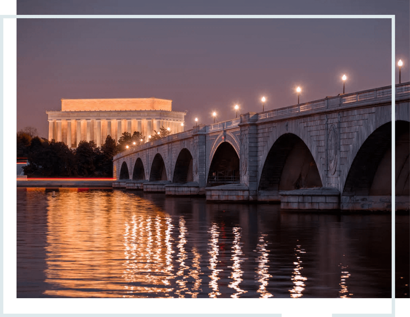 A photo of the Lincoln Memorial, the Arlington Memorial Bridge, and Potomac River during the evening.