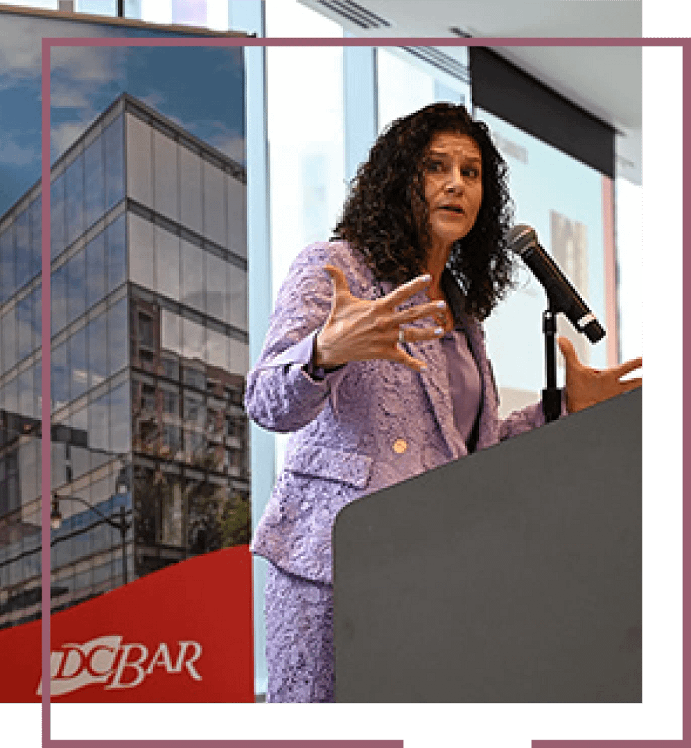 Diane speaking at a podium.